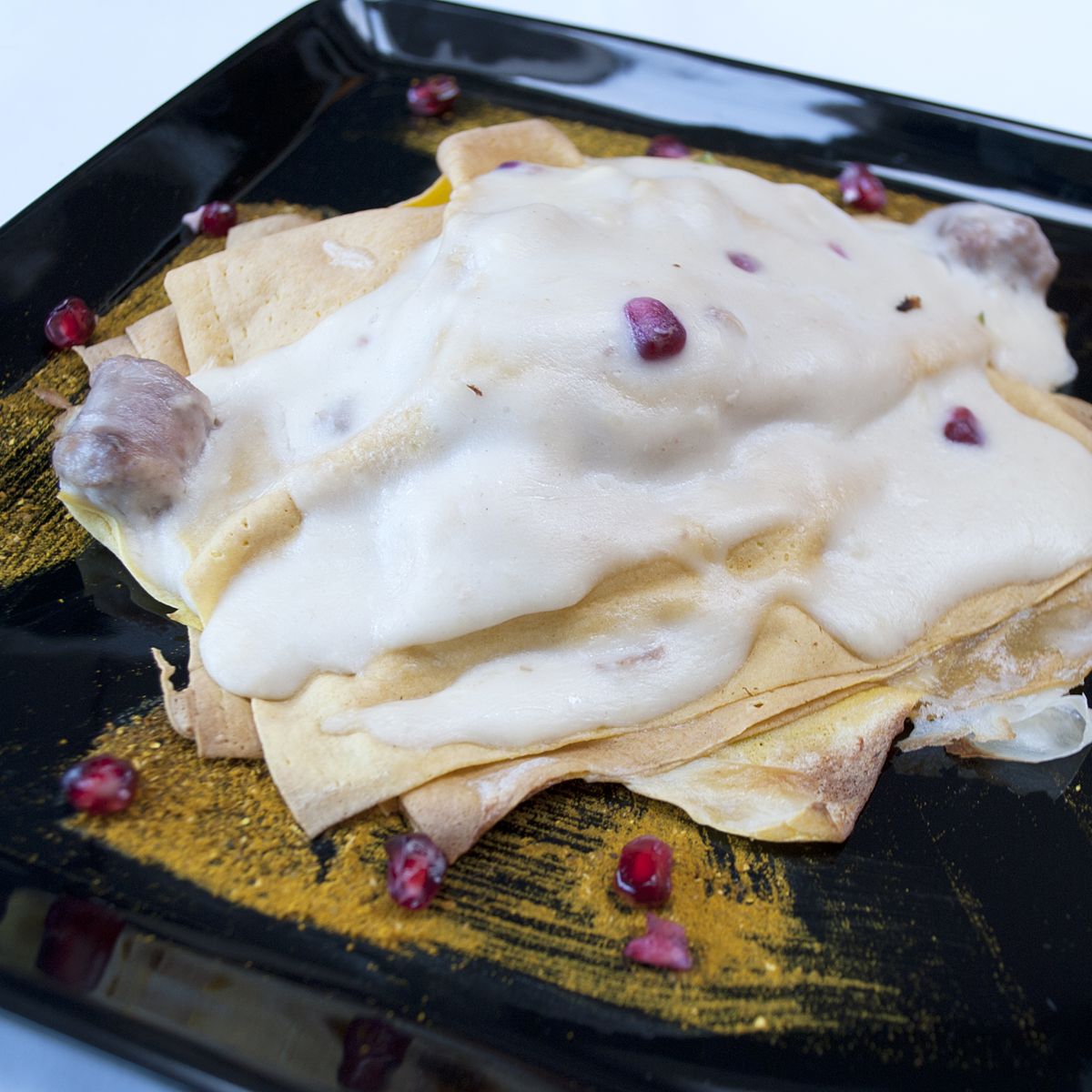 Lasagnetta di Crepes con salsiccia e melograno